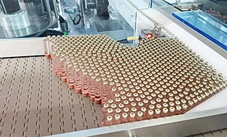 High-speed packaging machine processing bottles in a modern factory setting